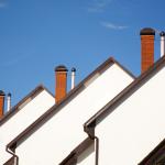 Front view of houses on a background of blue sky.