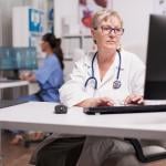 Doctor using computer in clinic.