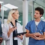 Health care staff having a standing meeting.