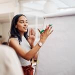 Woman and a whiteboard in office for training.