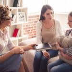 Mom and teenage daughter speaking with a counselor.