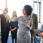 Group of businesspeople brainstorming together on a whiteboard