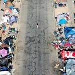 An aerial view of people gathered near a homeless encampment in the afternoon heat on July 21, 2022 in Phoenix.
