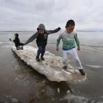 Schoolchildren play on melting ice at the climate change affected Yupik village of Napakiak on the Yukon Delta in Alaska on April 18, 2019.