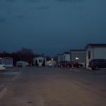 Dusk falls on cars parked next to mobile homes in a mobile park owned by a private equity firm in Smyrna, Tennessee. 