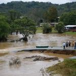 Residents that canoed the flooded South Fork New River talk at a washed out road on September 27, 2024 in Boone, North Carolina