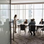 A business team engaged in a discussion in a meeting room.