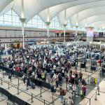 A high-angle view of a crowded TSA security checkpoint at Denver International Airport (DIA).