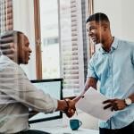 Two businessmen shaking hands after a meeting.