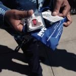 A Services for the UnderServed (S:US) worker holds a naloxone overdose kit.