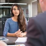 Young female professional meeting with a hiring manager during a job interview.
