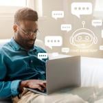 Man sitting on the couch at home using a laptop to chat with an AI bot.