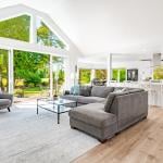 A large open living room with multiple expansive windows.