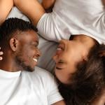A black couple enjoying intimacy in bed.