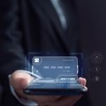 Businessman using an electronic credit card illustrated as a virtual screen.