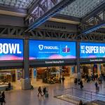 Ads for FanDuel, an online sports gambling copany, displayed on huge screens in the Moynihan Train Hall of Pennsylvania Station prior to the Super Bowl.