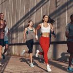 A group of people jogging outdoors.
