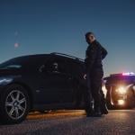 Police pulling a driver on the side to inspect driving behavior.
