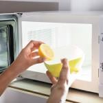 Microwave being cleaned with water and lemon.