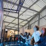 People interacting with a CityWorks exhibit exploring the water and wastewater infrastructure system.