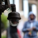 Close up of a video surveillance camera hanging from the side of a building in San Francisco. 