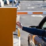 Person in the car paying for a parking ticket.