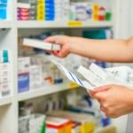 A pharmacist filling prescription at a pharmacy.
