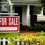 For sale sign in front of a house.