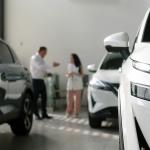 A manager and an interested buyer in a car dealership.