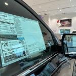 A car dealer's pricing sticker on a Toyota Tundra vehicle.