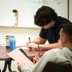 Students take notes during Dr. Adam Kaiserman's English class at College of the Canyons in Santa Clarita.