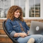 Woman sitting at home while browsing information using a laptop.