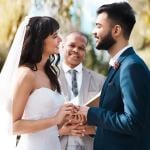 Happy couple exchanging vows during their wedding ceremony.