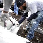 Karim Peoples help to make preparations to make it a cool roof in Baltimore.