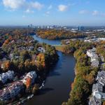 Aerial view of colorful fall trees surround lakes and homes in Fairfax County, Virginia. 