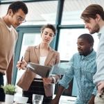 A creative team in an office analyzing expense management reports.