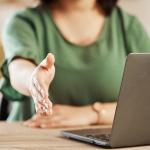 A woman extending her hand for a handshake.