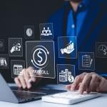 A payroll employee working on his laptop illustrated with payroll management system concept graphics.