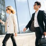Two business professionals on the way to their work.