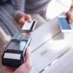 Person paying with a credit card at a cafe.