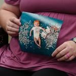 Elizabeth Goldman, an in-vitro fertilization patient at the University of Alabama at Birmingham, holds up a photo of her daughter who was born via the procedure.