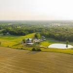 An aerial view of a small farm in southern Indiana during golden hour on a sunny summer day.