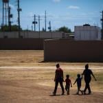 Immigrant woman and children walk across a field as U.S. Immigration and Customs Enforcement (ICE) and Enforcement and Removal Operations (ERO) hosts a media tour at the South Texas Family Residential Center, August 2019.