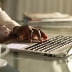 Close-up of a businessman using a laptop in the office at night.