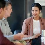 A female chief marketing officer in a meeting with her colleagues.