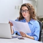A young businesswoman reading audit reports.