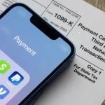 Payment apps on an iPhone and a Form 1099-K document.