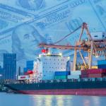 A crane loading a cargo ship at a shipping port.