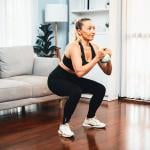 Woman at home in a leg day training session.