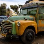 A vintage, old-timer school bus repurposed as a camper van.